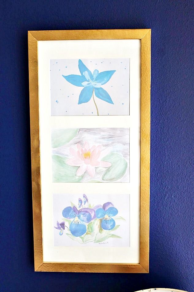 Gold frame with flowers on blue wall