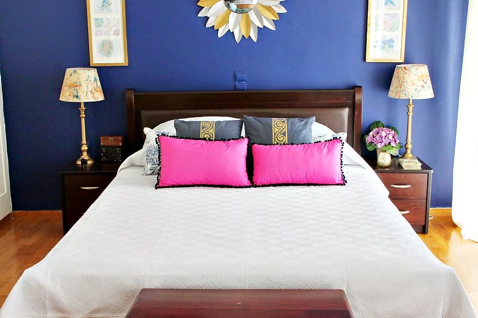 White duvet cover blue pillows with gold stencil and pink pillows