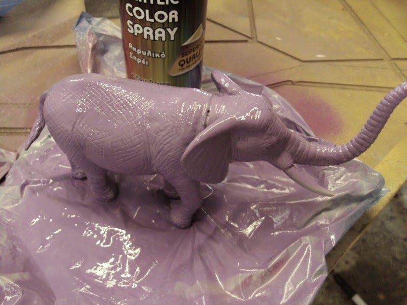 Purple spray paint on plastic elephant