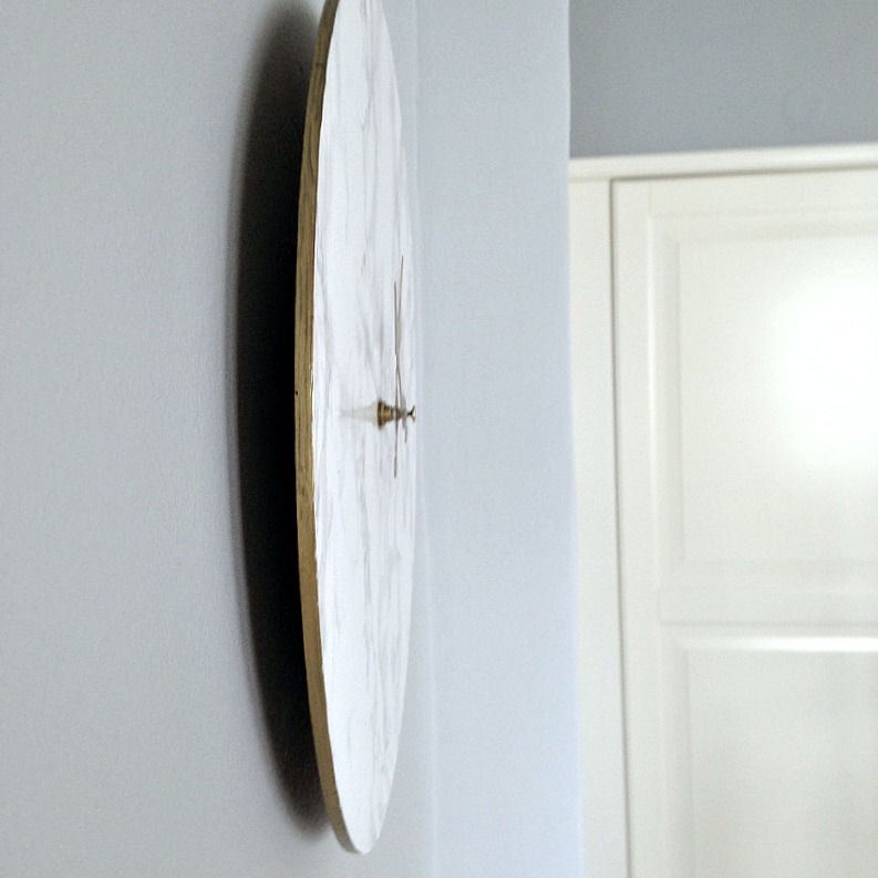 Faux marble clock on gray wall