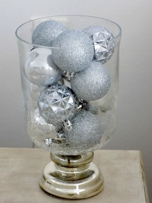 Glass pot filled with christmas balls